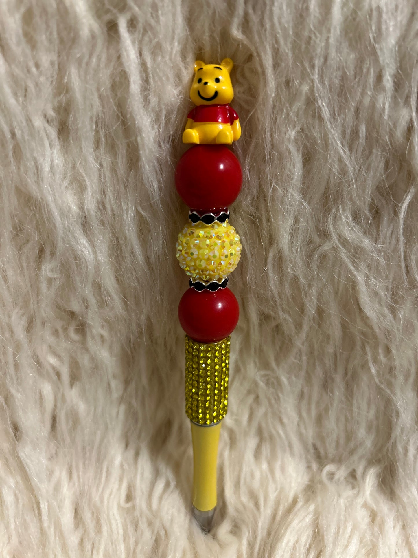 Red and yellow Winnie the Pooh pen